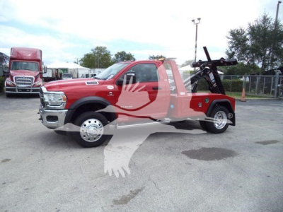 Winch-equipped red 2024 Ram 4500 pickup truck side view with towing equipment and logo watermark.