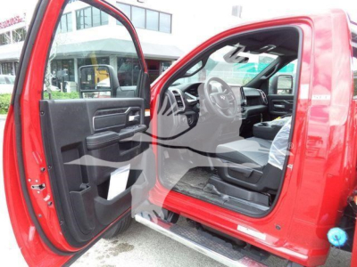 Ram 4500 SLT truck interior and open driver door showing steering wheel, dashboard, and front seat area.