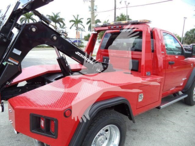 Ram 4500 SLT tow truck with winch and hydraulic arm in red, truck cab visible, logo and equipment labeling on hoist