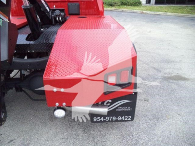 Ram 4500 winch work truck rear quarter panel showing red diamond plate bed and black bumper with white stock/phone label.