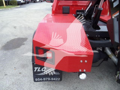 Front-left rear view of red Ram 4500 winch truck showing rear bumper with TLC Truck & Equipment logo and contact number 954-979-9422.