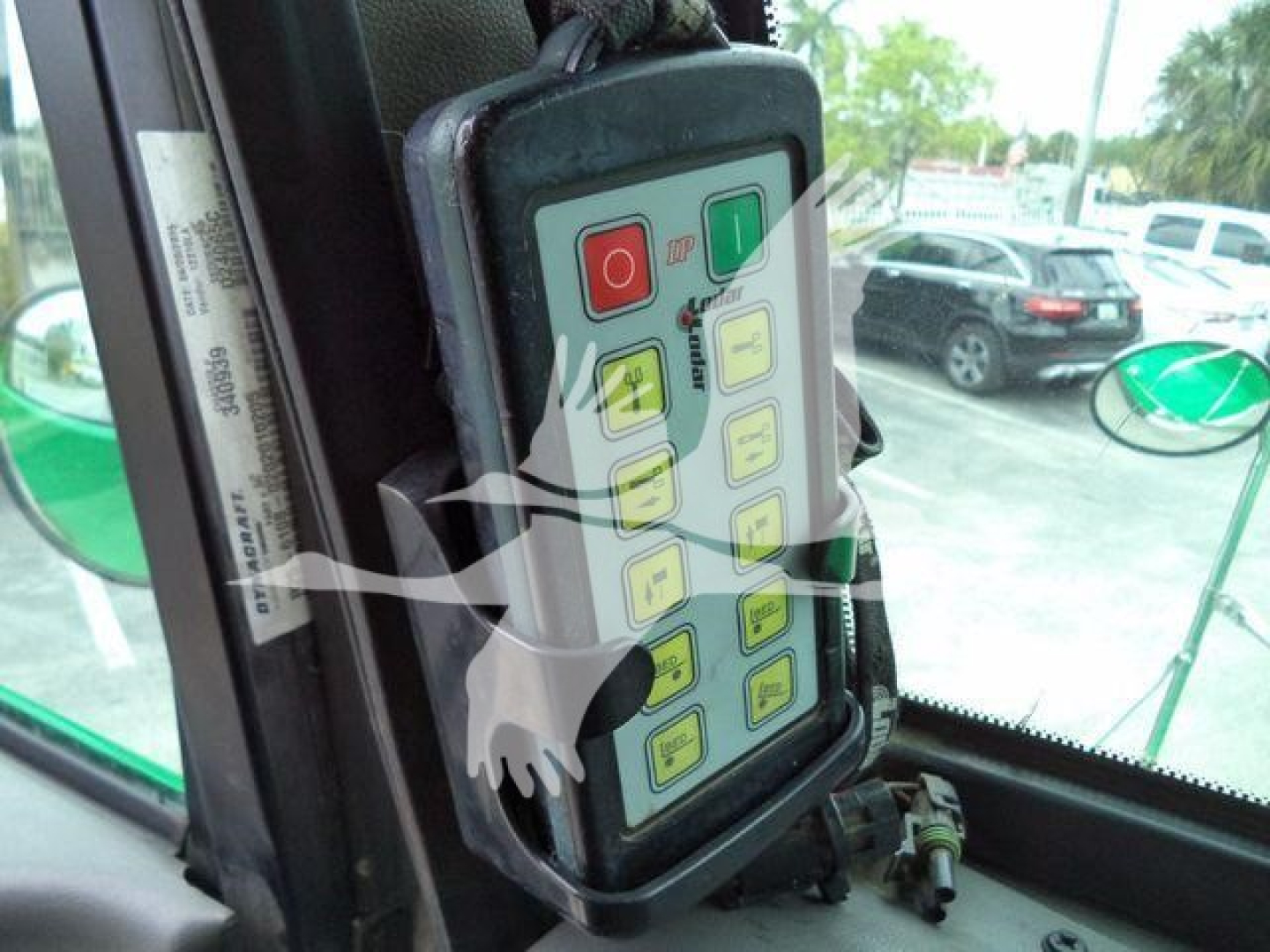 Panel inside truck cab with multi-button control module featuring red, green, and yellow labeled buttons.