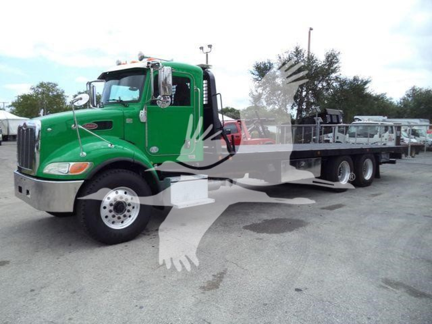 Green 2016 Peterbilt 348 rollback truck shown in side view with flatbed and crane, front grille, large wheels; stock number T40939FM visible in listing context.