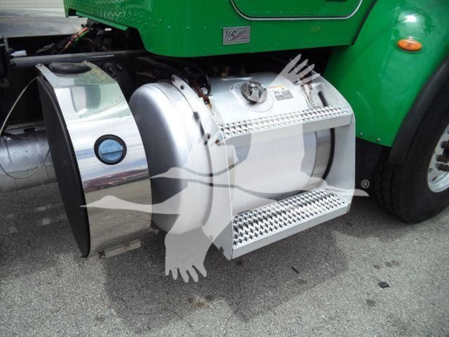 Peterbilt 348 fuel tank and steps on green truck side view showing chrome fuel tank and side step.