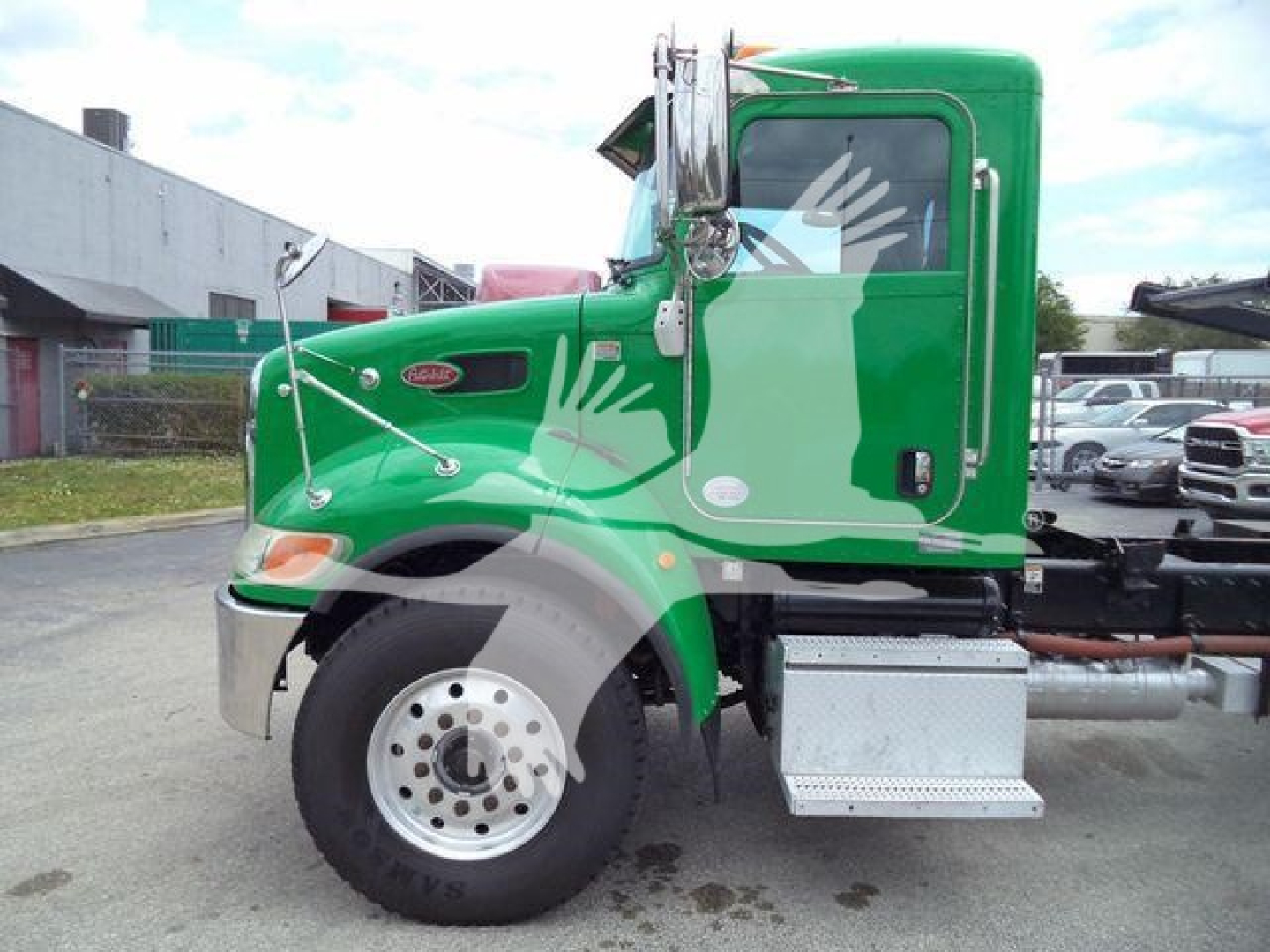 Green 2016 Peterbilt 348 cab with side step and front fender, visible wheel, side mirror, and company logo on door; stock number not visible in text.