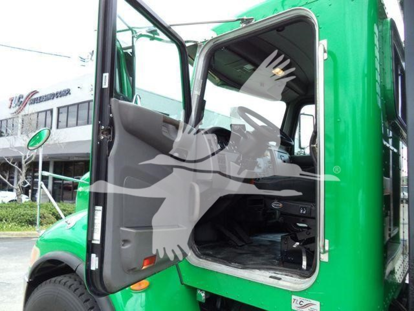 Peterbilt 348 rollback truck cab open door showing interior and step in green color.