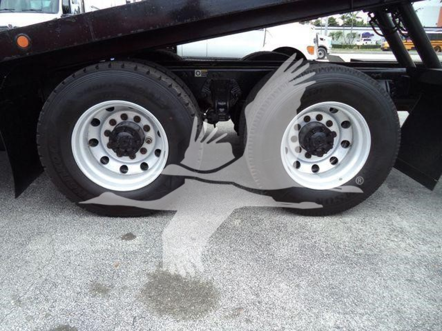 Peterbilt 348 rollback truck rear wheels and frame showing dual rear axle with tires and rims.