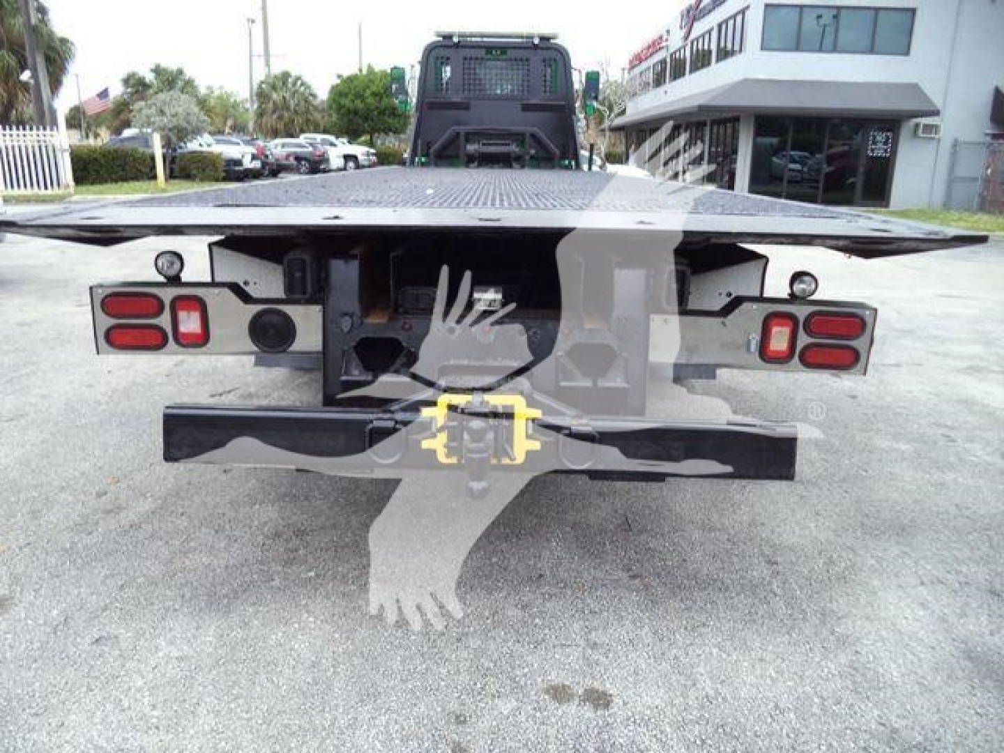 Peterbilt 348 rollback truck bed rear view showing taillights, hitch, and flatbed surface.