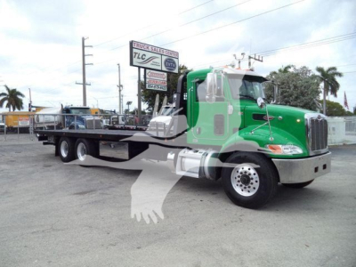 Peterbilt 348 rollback truck in green with flatbed, side view shows cab and dual rear axles. Visible text: no legible serials or logos aside from truck silhouette watermark.