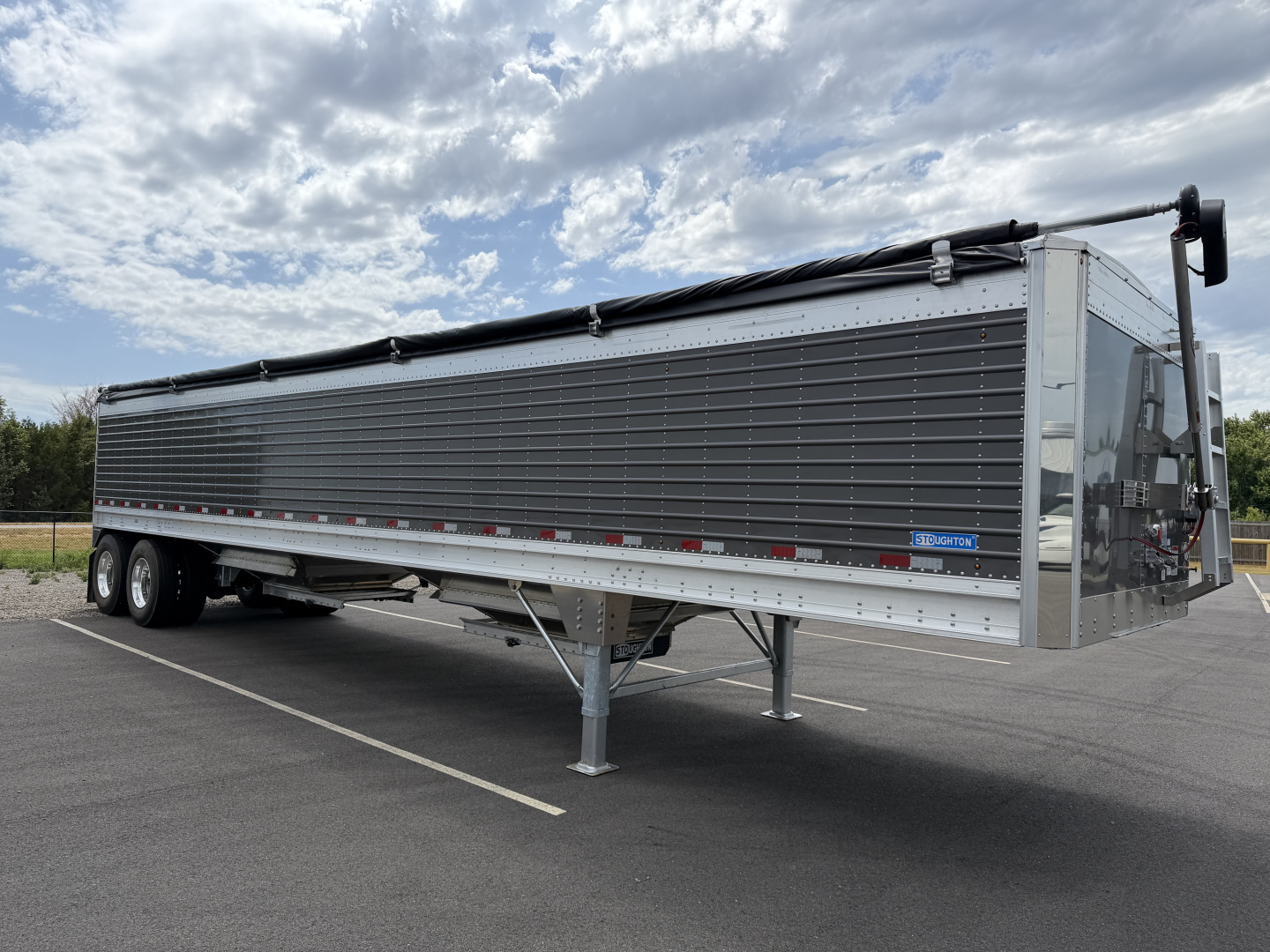 Stoughton 40' aluminum grain hopper trailer with 68" corrugated sidewalls, gray exterior, tandem axles, and front control box.