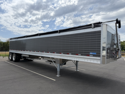 Stoughton 40' aluminum grain hopper trailer with 68" corrugated sidewalls, gray exterior, tandem axles, and front control box.