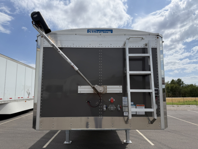 Stoughton 40' aluminum grain hopper trailer with 68 inch corrugated sidewalls, rear view showing unloading auger, toolbox, ladder, and stabilizer legs.