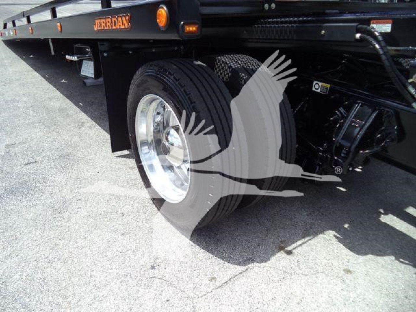 Peterbilt 337 rollback truck wheel and suspension visible with brand label Jordan on flatbed edge.