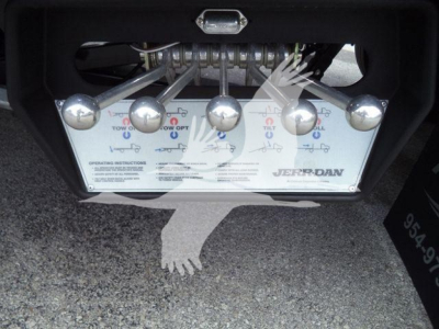 Peterbilt truck air intake plate with multiple levers and labels showing operating instructions and brand Jerr-Dan; hitch area above.