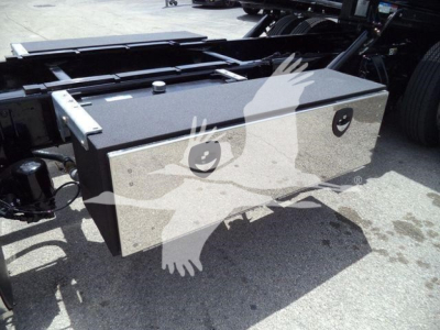 Peterbilt 337 rollback truck with a rectangular aluminum tool box mounted on the chassis showing two circular locks and hinges.