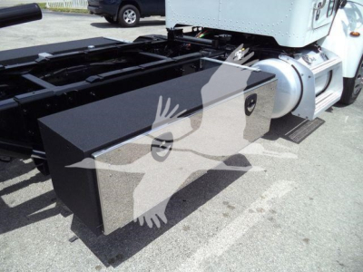 Truck chassis side view with large rectangular toolbox mounted near cab on Peterbilt 337 rollback truck.
