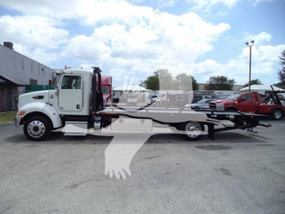 Peterbilt 337 rollback tow truck in side profile with flatbed, white cab, black frame, and loading ramp.