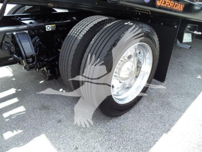Peterbilt 337 rollback truck wheel and front suspension showing dual rear wheels and front axle; tire tread and chrome wheel visible.