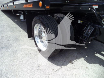 Peterbilt 337 rollback truck wheel and suspension visible with brand label Jordan on flatbed edge.