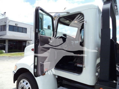 Peterbilt 337 truck cab with open door showing interior and rollback truck setup