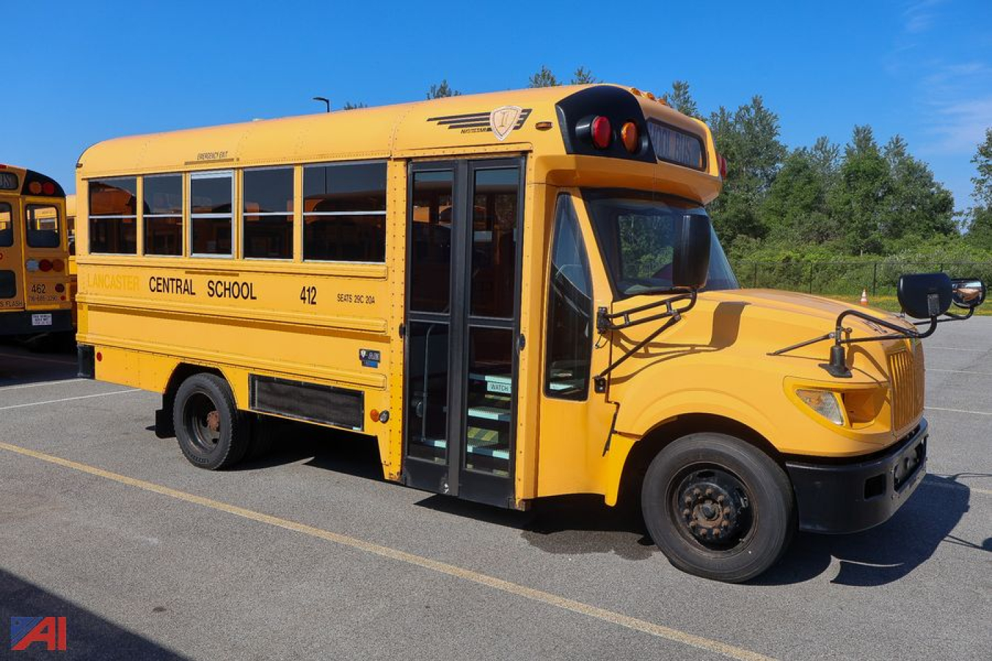 School bus side view showing Central School text and bus number 412, open door, yellow IC Corporation AE Series mid-size school bus.