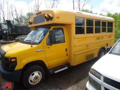 Yellow 2008 Ford E-450 Thomas mobility bus side view showing wheelchair bus with windows and dual rear wheels.