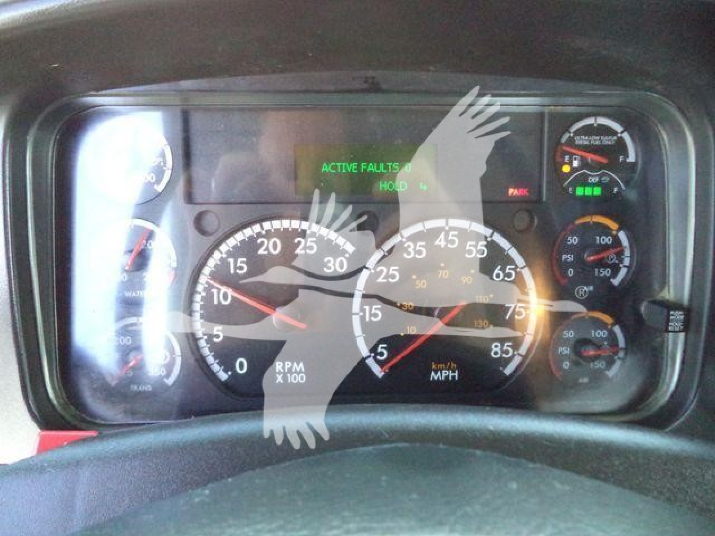 Dashboard of a Freightliner M2 106 showing analog gauges including RPM, MPH, and various gauges with a green 'ACTIVE FAULTS' indicator on the digital display.