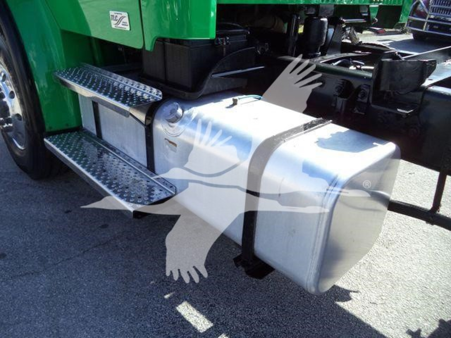 Truck fuel tank and side step view showing chrome steps and undercarriage of a 2016 Freightliner M2 106 rollback truck.