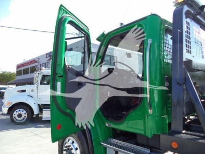 Green Freightliner M2 106 cab interior shown with open door and steps