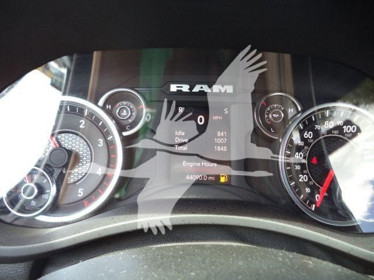 Ram dashboard cluster showing speedometer and gauges with RAM logo and digital readouts.
