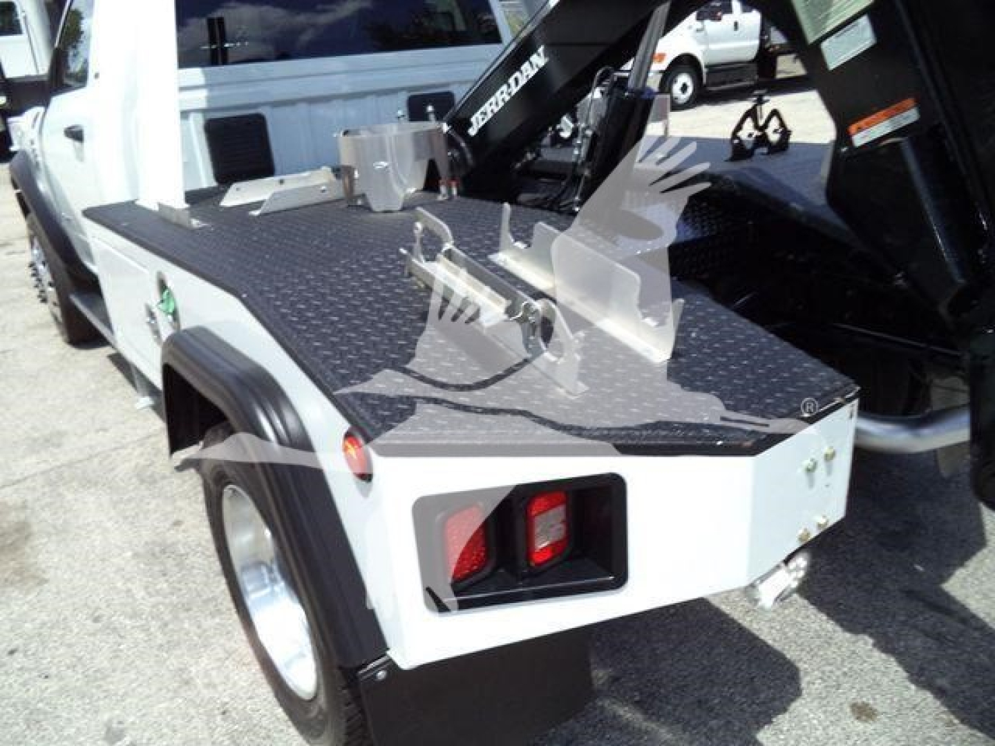 Ram 4500 flatbed utility truck with rear winch and diamond plate surface; visible text on equipment includes 'BERGIN' on winch arm and tail light housings.