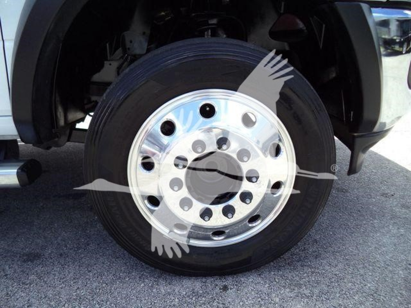 Wheel close-up on Ram 4500 SLT showing front tire and polished steel rim with multiple lug nut holes.