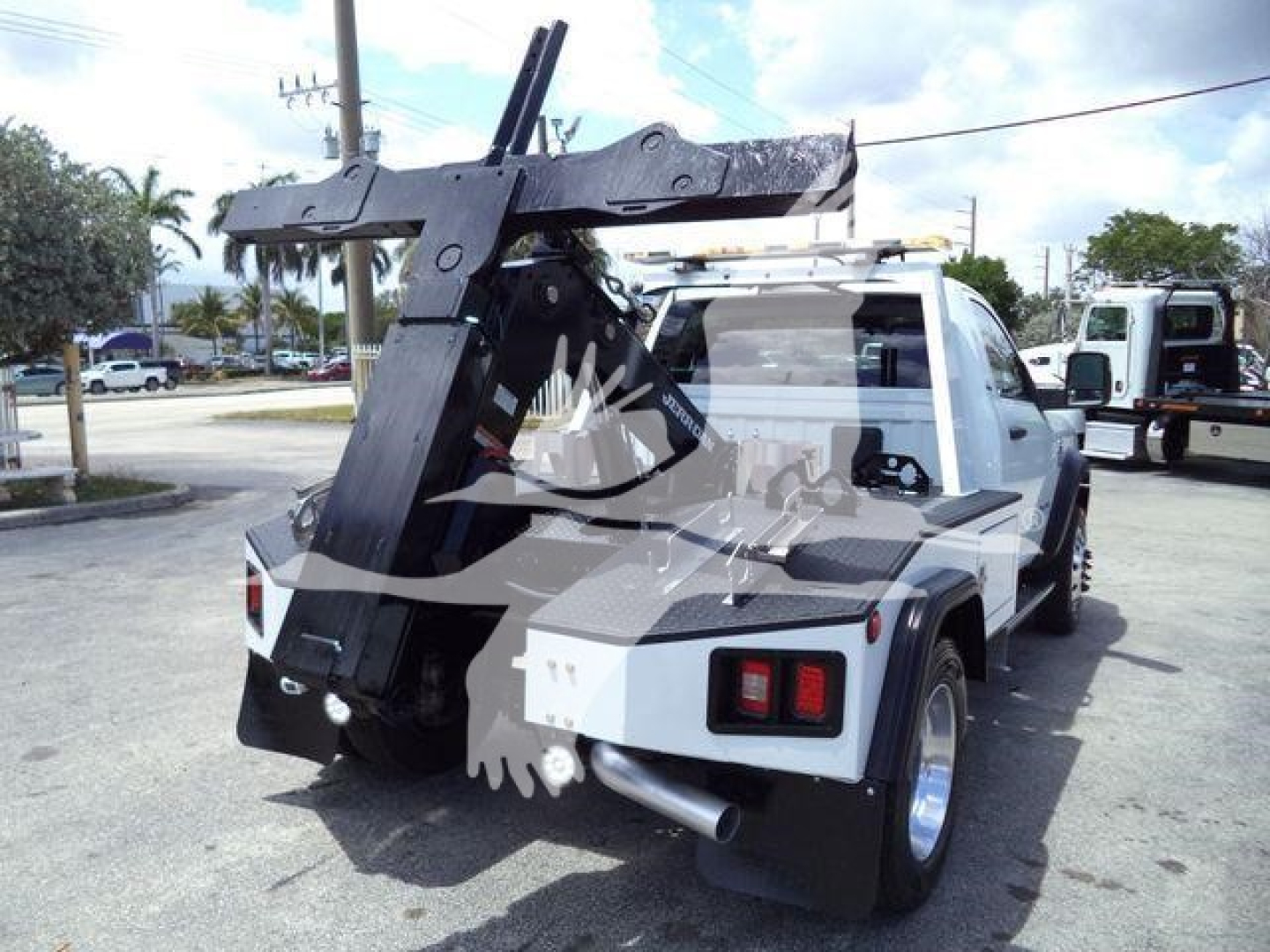 Truck bed with hydraulic/winch mount on Ram 4500 SLT, viewing rear-right side, showing crane and winch apparatus.
