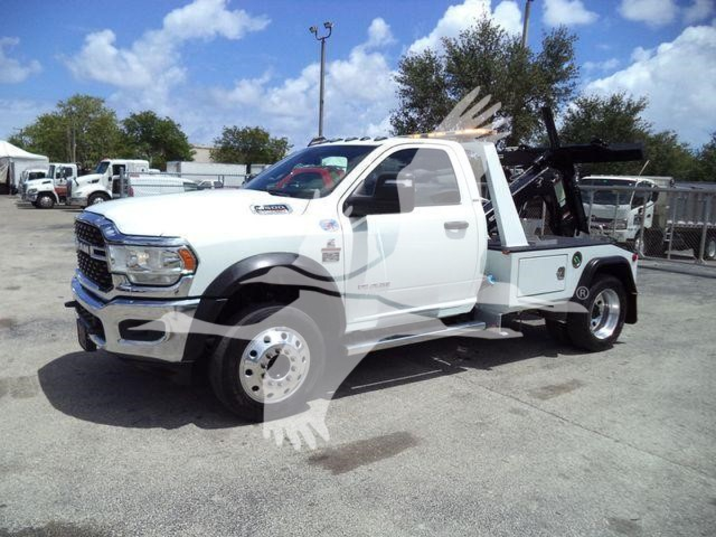 Ram 4500 tow truck with winch equipment and racks, white cab, stock number T83037FM, in-service condition.