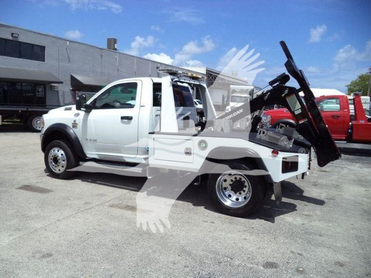 Ram 4500 tow/winch truck in-service view showing front cab and rear bed with mounted winch and equipment