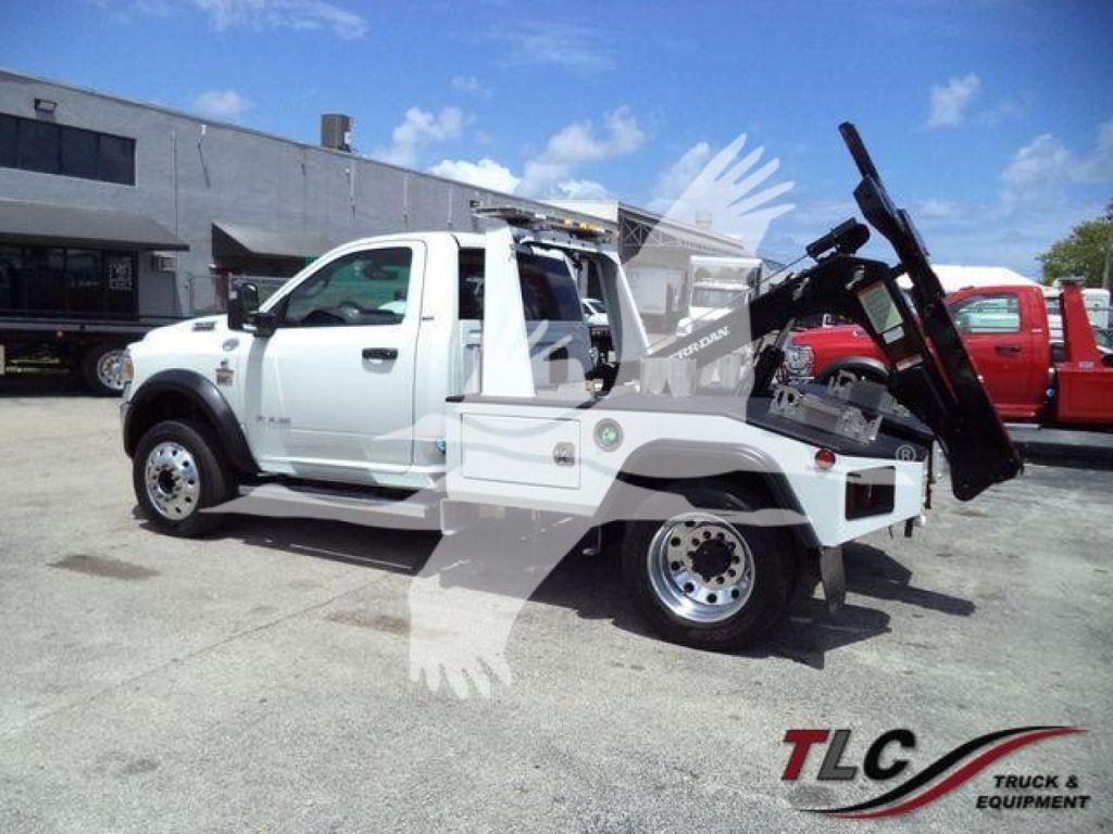 Ram 4500 tow bed utility truck with winch and accessories, white, side view.