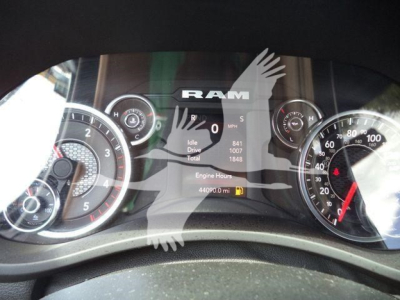 Ram dashboard cluster showing speedometer and gauges with RAM logo and digital readouts.
