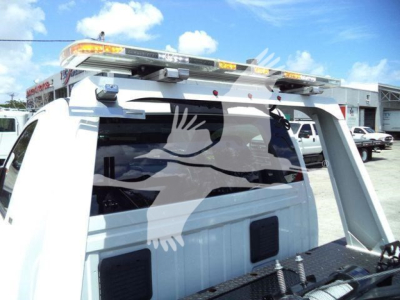 Ram 4500 SR towing setup showing roof rack with light bar and winch equipment on a white service truck.
