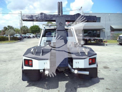 Ram 4500 tow truck rear view with large heavy-duty hitch and winch attachment, rear lights, and bumper.