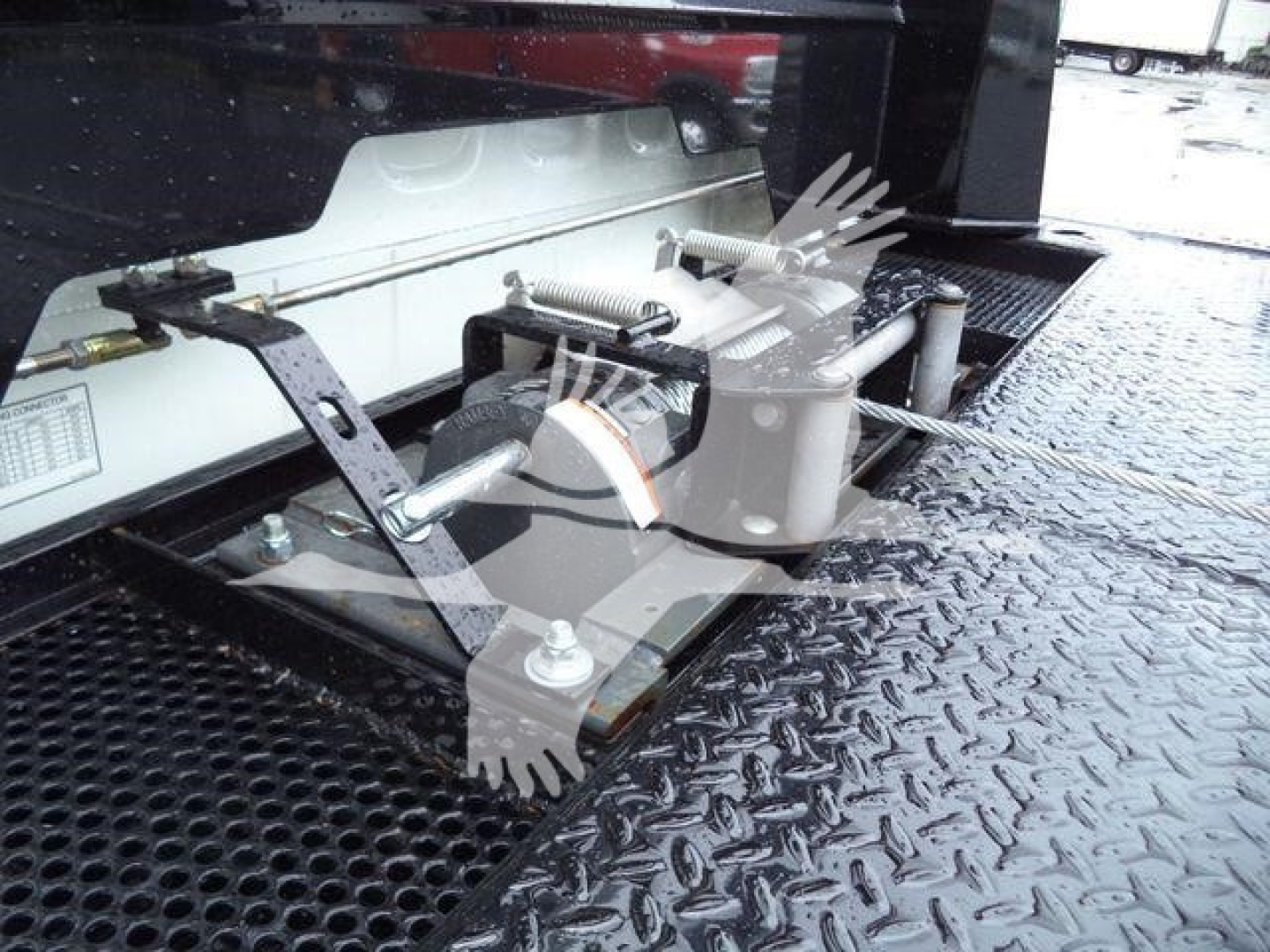 Freightliner M2 106 rollback truck hitch assembly and platform showing towing brackets and mechanical components.