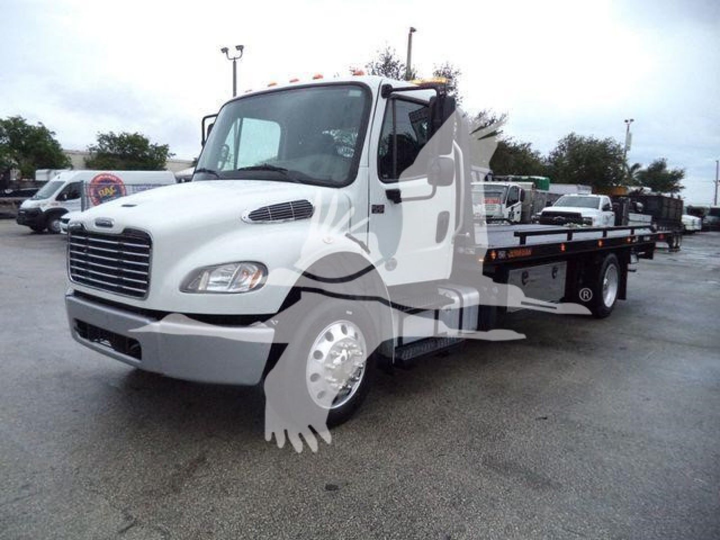 Truck image showing a white 2020 Freightliner M2 106 rollback wrecker chassis with flatbed and hydraulic system, front grille, headlights, and side mirrors.