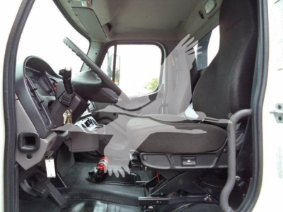 Truck cab interior of a 2020 Freightliner M2 106 rollback unit showing driver seat and dashboard with steering wheel, pedals, and gear selector.