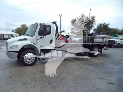  Freightliner M2 106 rollback truck showing side view with white cab and flatbed, stock number visible in listing.