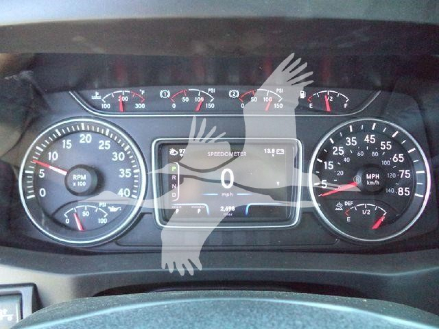 Dashboard of a new International MV rollback truck showing speedometer, tachometer, and central digital display with gauges and indicators.