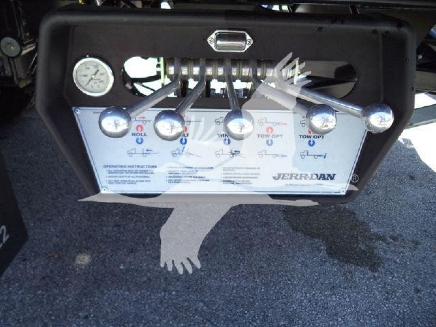 Panel with multiple levers and gauges labeled JERR-DAN and Tow/Off with instruction plate, hydraulic controls visible.