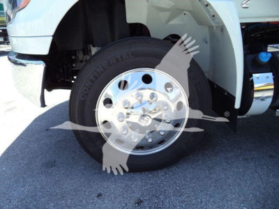 Truck front wheel and fender showing Continental tire and polished aluminum wheel with lug nuts.