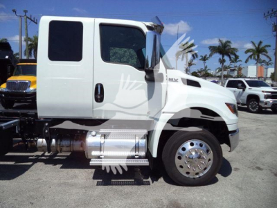 Truck cab side view showing white 2027 International MV rollback truck with dual rear wheels, side exhaust, and chrome fuel tank