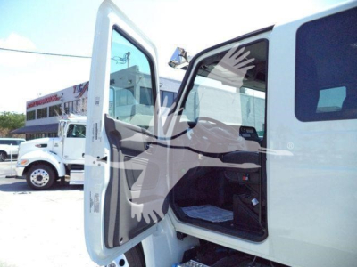 Truck door open showing interior cab of a 2027 International MV rollback truck.