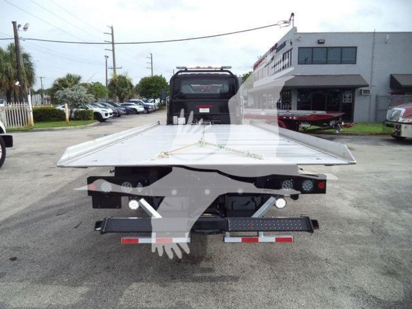 Flatbed tow truck bed rear view showing loading platform and tail lights on a new 2026 International MV rollback truck.