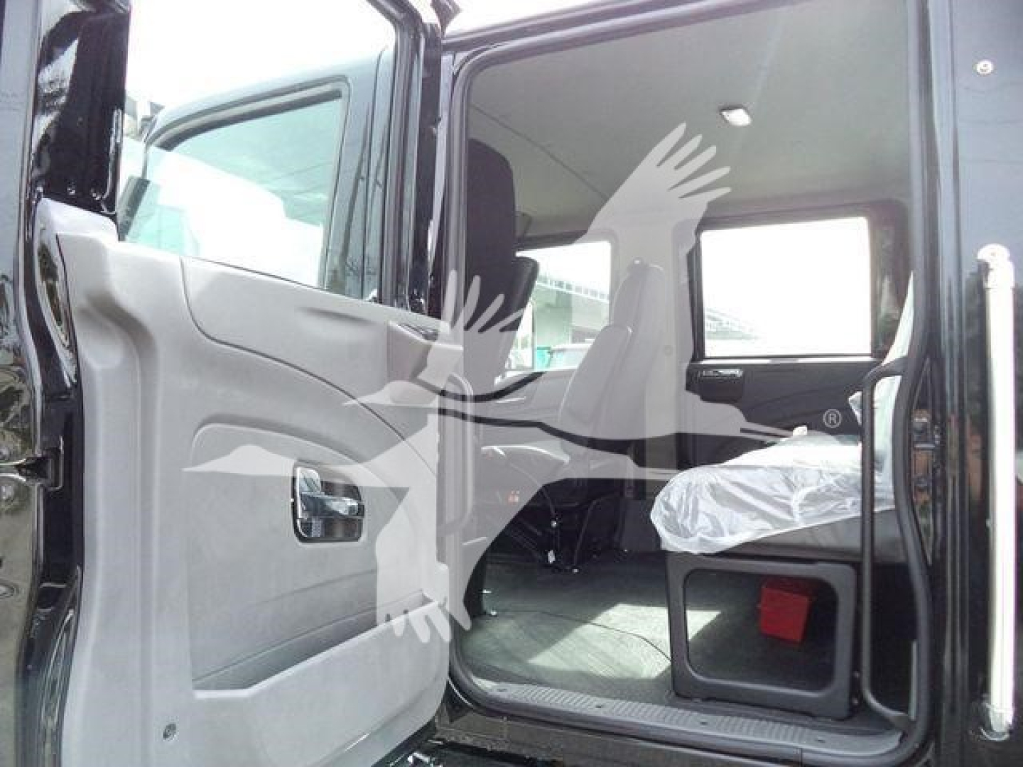 International MV truck cab interior side view showing open door and seating area.